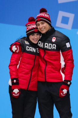 Tessa Virtue & Scott Moir share an embrace during the medal ceremony for the Team Event. (Photo: Greg Kolz)