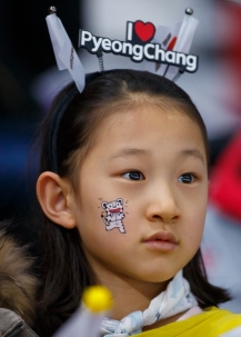 A young Korean fan watches intently as the Men's 5,000m event unfolds at the Gangneung Oval. (Photo: Greg Kolz)