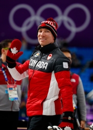 Canadian speed skater Ted-Jan Bloeman in the shadow of the Olympic Rings following the Men's 5,000m race.
