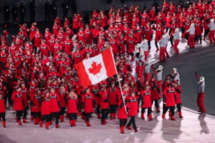 February 9, 2018: Flagbearers Tessa Virtue & Scott Moir lead Team Canada into PyeongChang Olympic Stadium during the Opening Ceremony. (PHOTO: Greg Kolz)