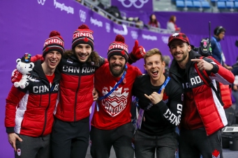February 17, 2018: Short track teammates Charle Cournoyer, Samuel Girard, Charles Hamelin, Pascal Dion, and Francois Hamelin celebrate their bronze mdeal result in the men's 5000m relay. (PHOTO: Greg Kolz)